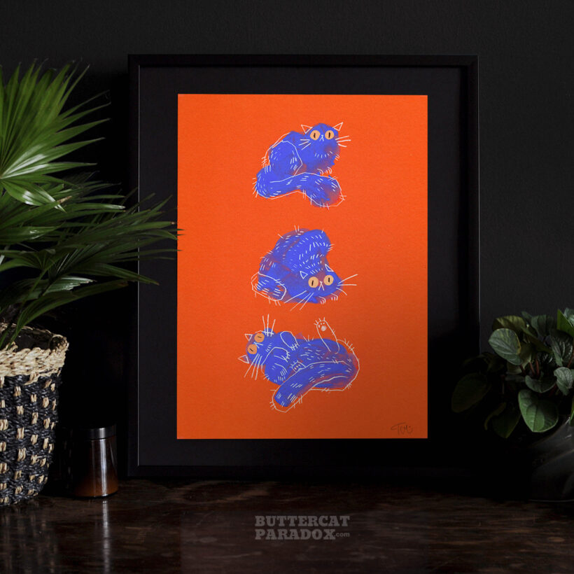 Art print of three blue cats on a bright red background. Signed by the artist Tereza Kovandová aka Buttercat Paradox.